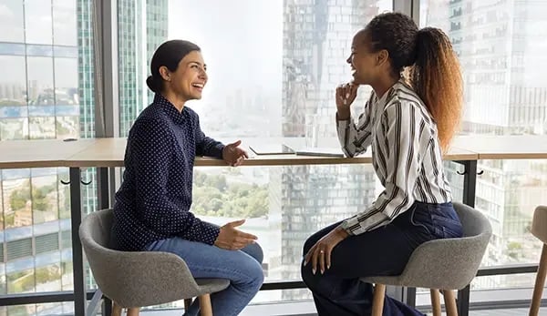 two women at work talking