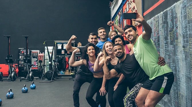 Fitness enthusiasts taking a selfie in the gym.