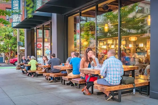 People dine on a patio in a San Francisco restaurant in the afternoon.