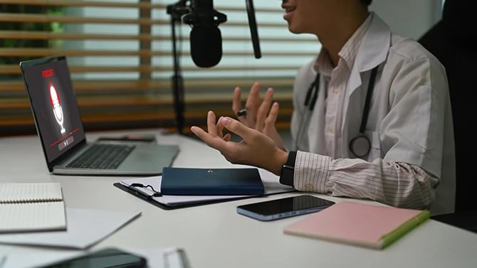 Cropped shot of a doctor in white coat giving medical advice on an online platform.