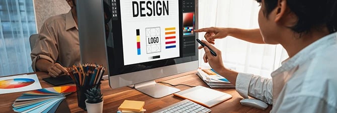 Graphic designer work on computer, designing website for optimal user experience.