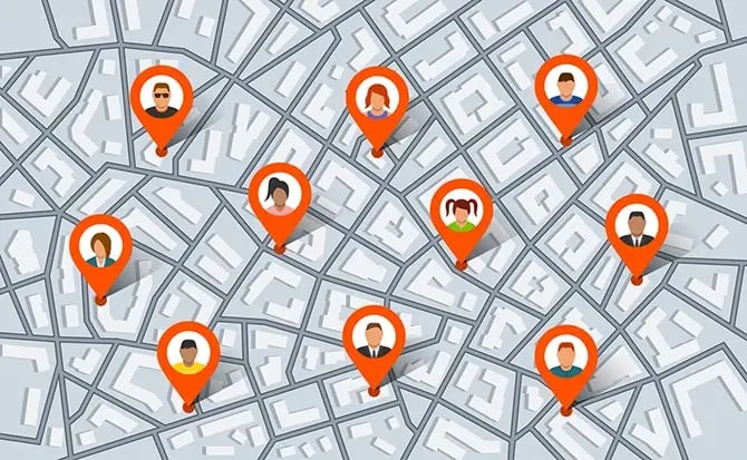 Pointer pins on city map with people as targeted audience.